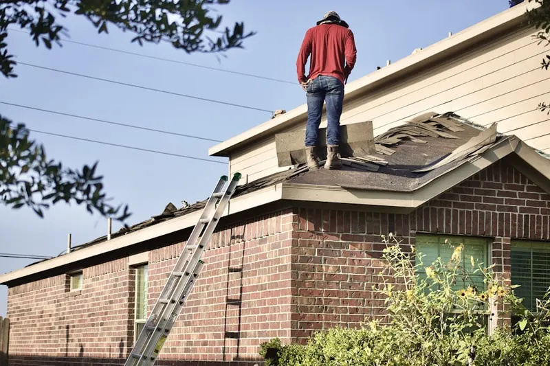Professional roofer working on a residential roof in Hubbard Woods